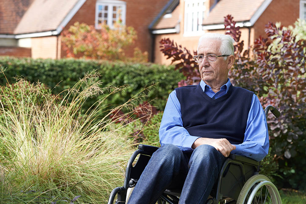 older man is sitting in garden A black and white image of a phone.