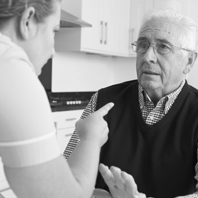 Nurse is abusing an old man A black and white image of a phone.